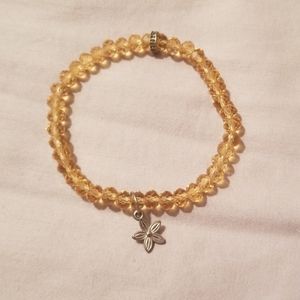 Amber bracelet with star flower charm
